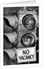 No vacancy sign by traffic lights with birds' nests inside by Anonymous
