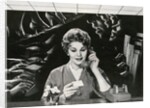 Woman Office Worker on the Phone Distracted by Noise. by Corbis