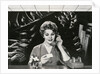 Woman Office Worker on the Phone Distracted by Noise. by Corbis