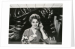 Woman Office Worker on the Phone Distracted by Noise. by Corbis