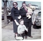 Young family dressed in the Sunday best, ca. 1960. by Anonymous