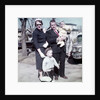 Young family dressed in the Sunday best, ca. 1960. by Anonymous