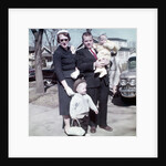 Young family dressed in the Sunday best, ca. 1960. by Anonymous