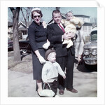Young family dressed in the Sunday best, ca. 1960. by Anonymous