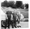 A lineup of kids by the family car. 1965. by Anonymous