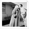 Young husband and wife kiss, ca. 1955. by Anonymous