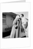 Young husband and wife kiss, ca. 1955. by Anonymous