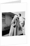 Young husband and wife kiss, ca. 1955. by Anonymous