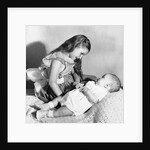 Big sister looks down on her baby brother, ca. 1948 by Anonymous