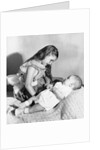Big sister looks down on her baby brother, ca. 1948 by Anonymous