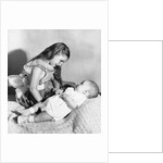 Big sister looks down on her baby brother, ca. 1948 by Anonymous
