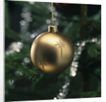 Close-up of a golden hanging Christmas bauble on blurred tree by Anonymous