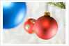Close-up of hanging red and blue Christmas baubles by Anonymous