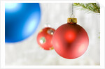 Close-up of hanging red and blue Christmas baubles by Anonymous