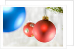 Close-up of hanging red and blue Christmas baubles by Anonymous