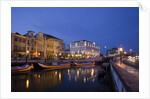 Moliceiro boats docked by Art Nouveau style buildings along the Central Canal by Anonymous