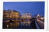 Moliceiro boats docked by Art Nouveau style buildings along the Central Canal by Anonymous
