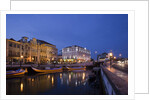Moliceiro boats docked by Art Nouveau style buildings along the Central Canal by Anonymous