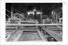 A worker stands over a rock or gravel processing facility, ca. 1910 by Anonymous