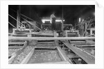 A worker stands over a rock or gravel processing facility, ca. 1910 by Anonymous