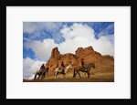 Riders passing under the Red Rock Hills of the Big Horn Mountains by Anonymous
