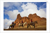 Riders passing under the Red Rock Hills of the Big Horn Mountains by Anonymous