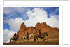 Riders passing under the Red Rock Hills of the Big Horn Mountains by Anonymous