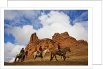 Riders passing under the Red Rock Hills of the Big Horn Mountains by Anonymous