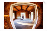 Cowgirl in doorway of old cabin by Anonymous