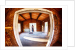 Cowgirl in doorway of old cabin by Anonymous