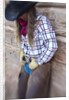 Cowgirl outside cabin by Anonymous