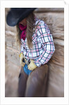 Cowgirl outside cabin by Anonymous
