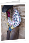 Cowgirl outside cabin by Anonymous
