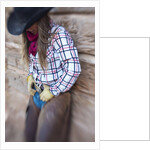 Cowgirl outside cabin by Anonymous