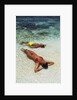 1990s Couple Sunbathing In Shallow Water At The Ocean's Edge by Anonymous