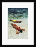 1990s Couple Sunbathing In Shallow Water At The Ocean's Edge by Anonymous