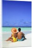 1990s Man And Woman Sitting On The Beach Facing The Water Mopion Island, Grenadines, West Indies by Anonymous