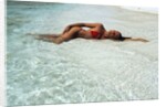 1990s Woman In Red Bikini Lying In Shallow Water On The Beach by Anonymous