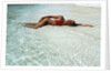 1990s Woman In Red Bikini Lying In Shallow Water On The Beach by Anonymous