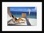 1990s Woman Wearing Black And Gold Bathing Suit Sunbathing On Patio In Deck Chair by Anonymous