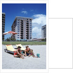 1990s Young Family On Beach Playing In The Sand by Anonymous