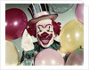 1950s Circus Clown Portrait Smiling Amid Balloons Pointing Up Looking At Camera by Anonymous