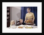 1960s Grandmother Presenting Roasted Turkey To Children At Dining Room Table by Anonymous