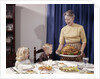 1960s Grandmother Presenting Roasted Turkey To Children At Dining Room Table by Anonymous