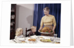 1960s Grandmother Presenting Roasted Turkey To Children At Dining Room Table by Anonymous