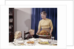 1960s Grandmother Presenting Roasted Turkey To Children At Dining Room Table by Anonymous