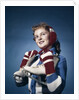 1960s Smiling Woman Wearing Red Mittens Ear Muff Blue Sweater Holding Ice Skates by Anonymous