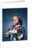 1960s Smiling Woman Wearing Red Mittens Ear Muff Blue Sweater Holding Ice Skates by Anonymous