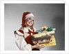 1960s Young Woman In Red And White Santa Helper Costume And Hat Holding Pile Of Wrapped Christmas Presents Studio by Anonymous