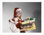 1960s Young Woman In Red And White Santa Helper Costume And Hat Holding Pile Of Wrapped Christmas Presents Studio by Anonymous
